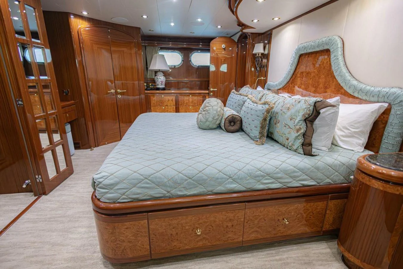 The master stateroom features a luxurious bed with elegant bedding and rich wood finishes. aboard BOBBI TOO Yacht for Sale