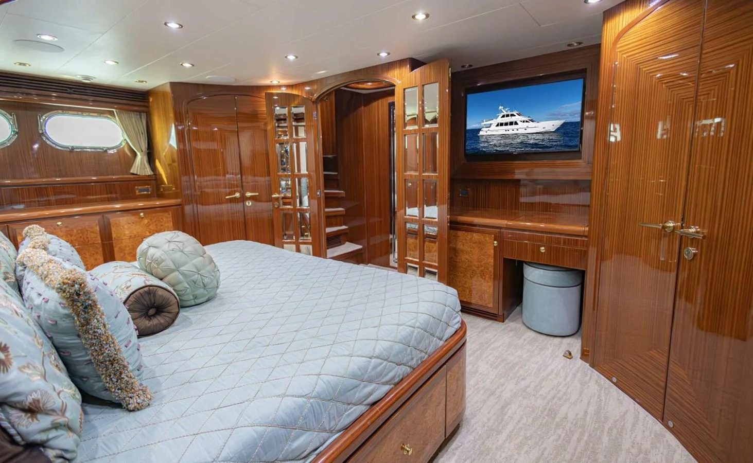 The master stateroom features luxurious wood finishes, a large bed, and a flat-screen TV for ultimate comfort. aboard BOBBI TOO Yacht for Sale