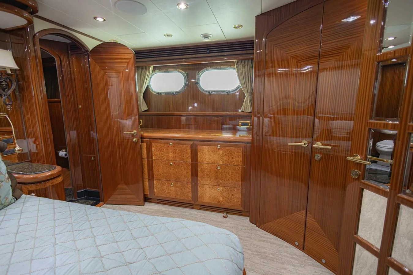 The stateroom features elegant wood paneling and luxurious furnishings. aboard BOBBI TOO Yacht for Sale