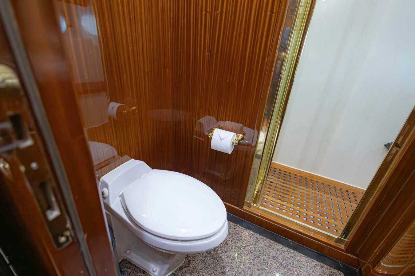 The yacht's bathroom features a sleek design with wooden paneling and modern fixtures. aboard BOBBI TOO Yacht for Sale