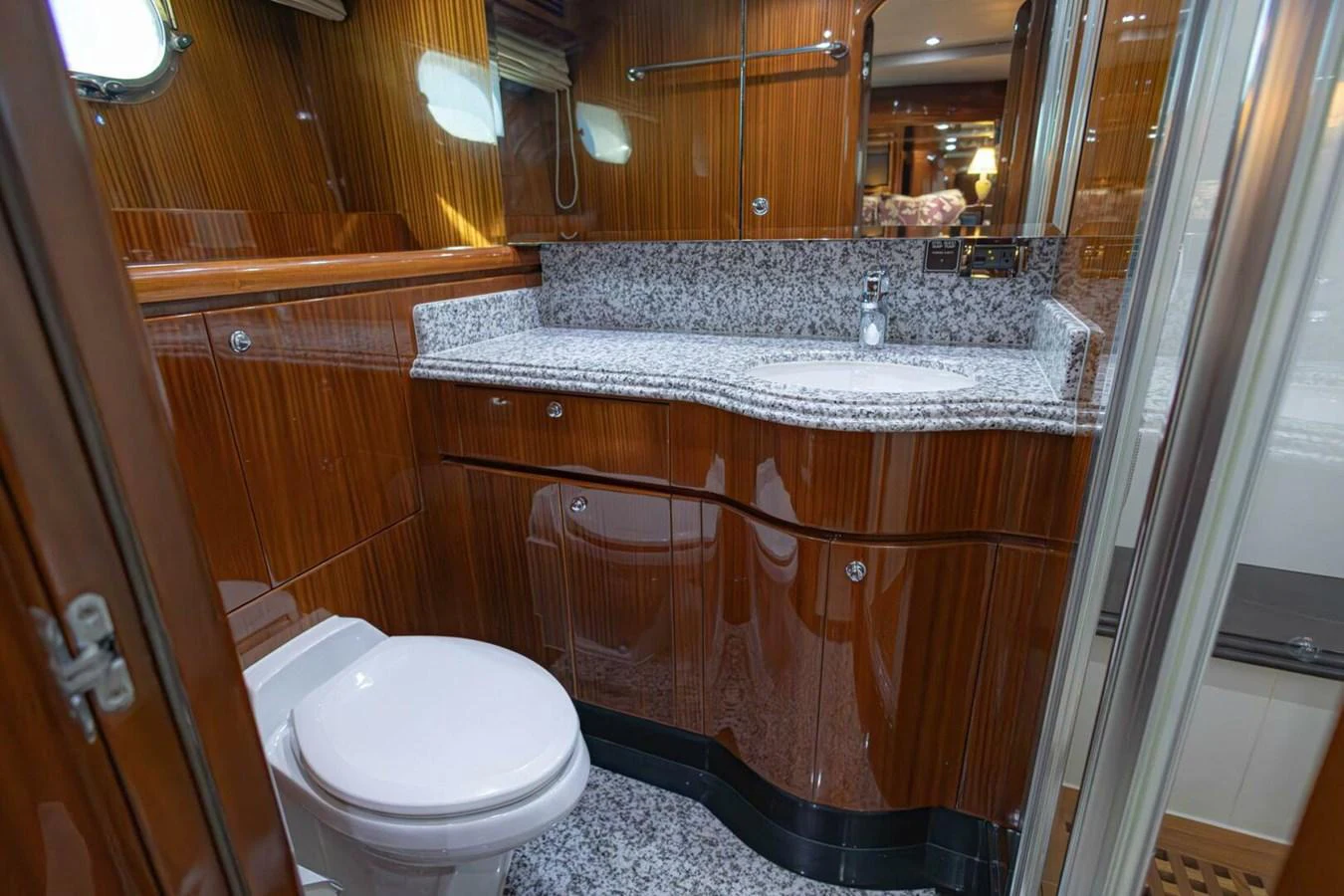 The yacht's bathroom features luxurious wood paneling and a granite countertop. aboard BOBBI TOO Yacht for Sale