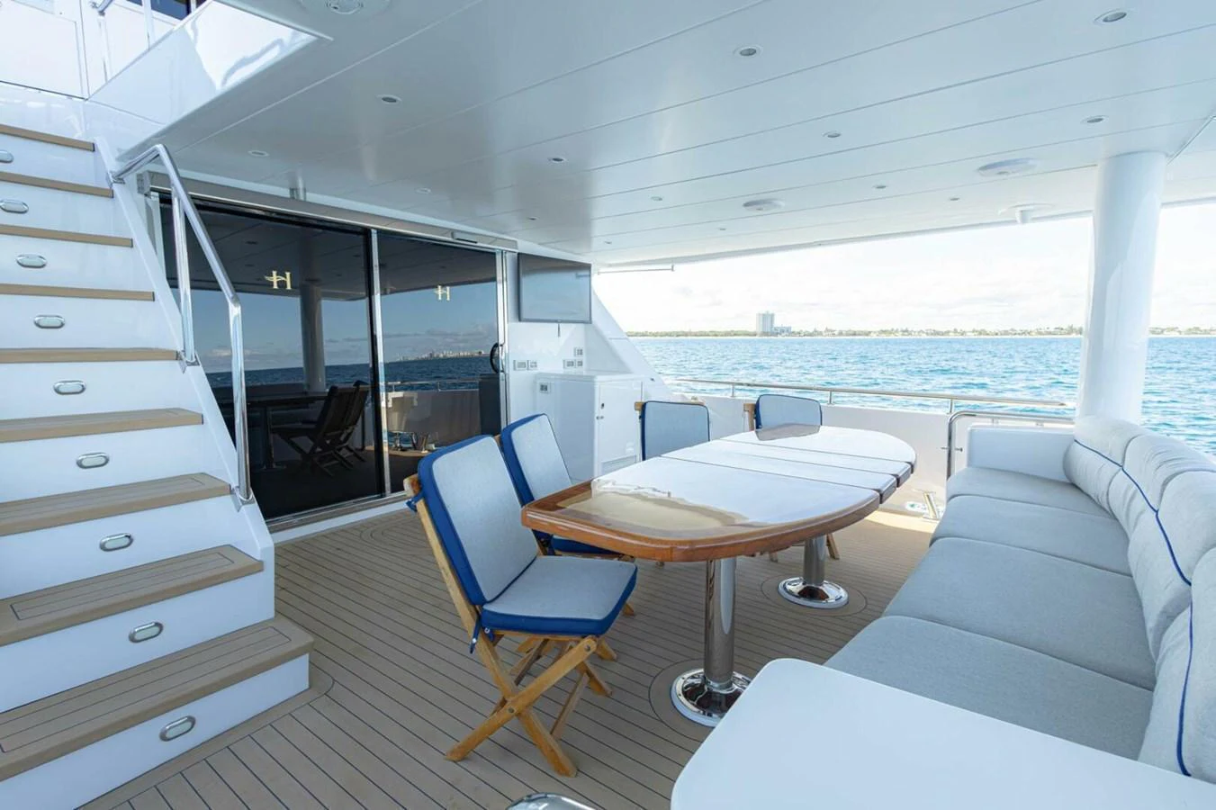 The aft deck offers a comfortable seating area with a dining table and easy access to the water. aboard BOBBI TOO Yacht for Sale
