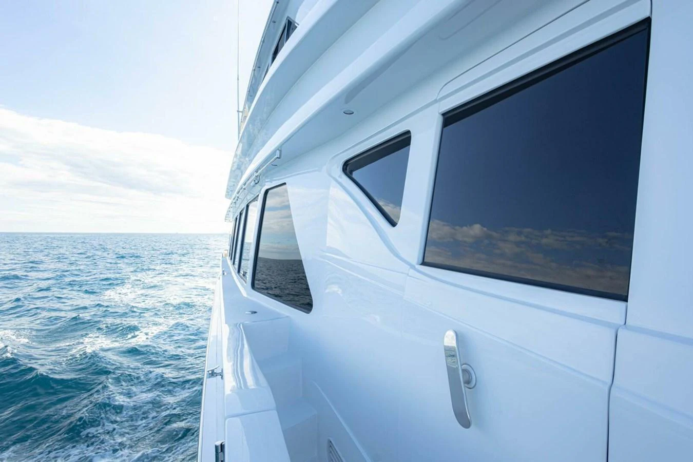 The sleek exterior of the yacht glides smoothly over the open sea, showcasing its modern design and expansive windows. aboard BOBBI TOO Yacht for Sale