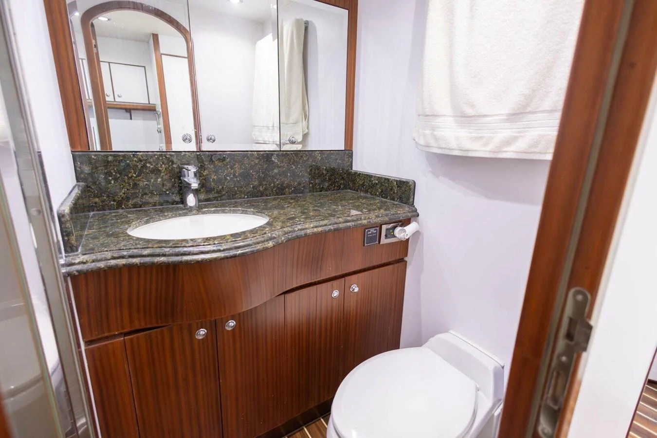 The yacht's bathroom features a sleek vanity with a granite countertop and a modern sink. aboard BOBBI TOO Yacht for Sale