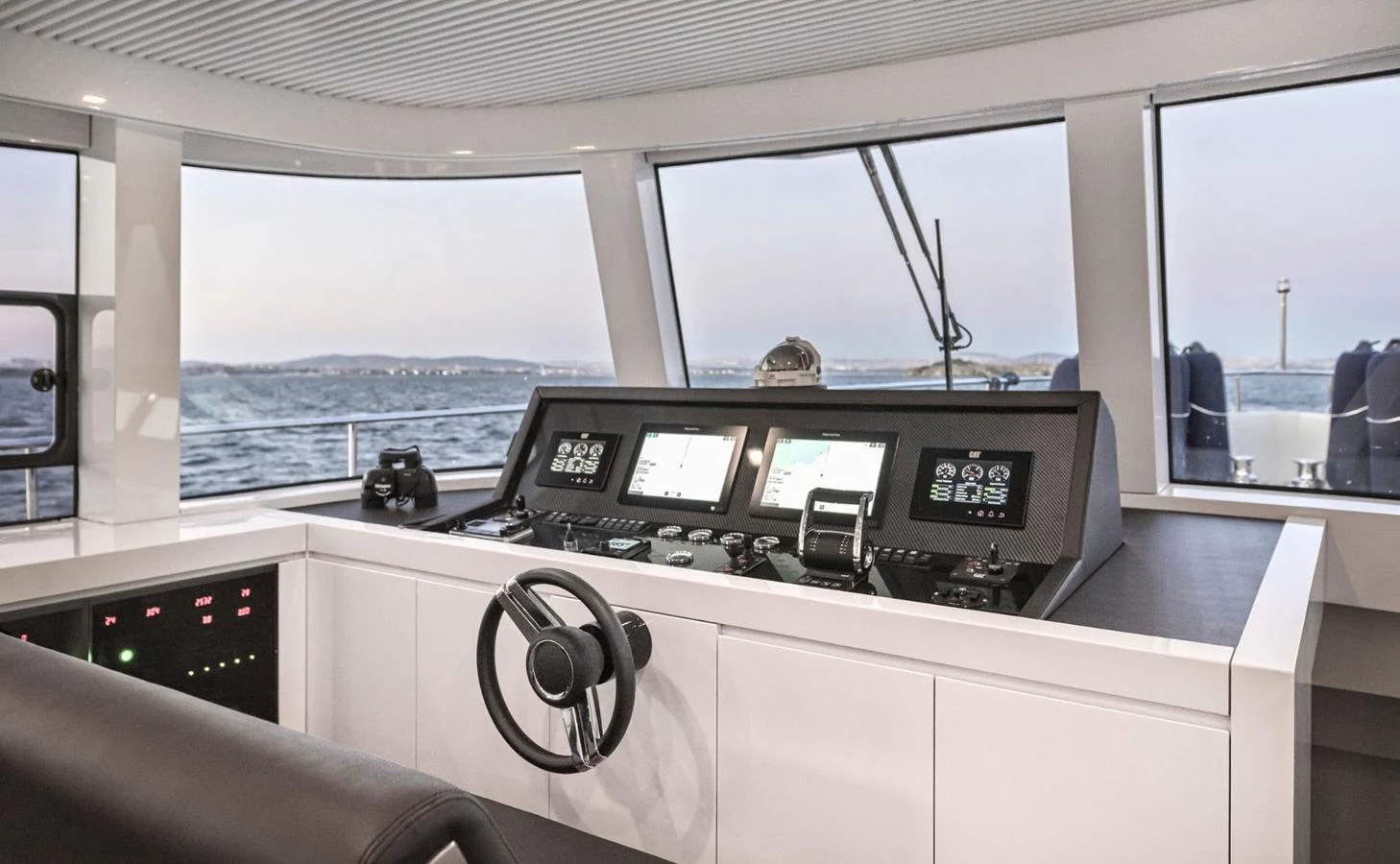 a room with a large window and a couple of monitors aboard ATLASS Yacht for Sale