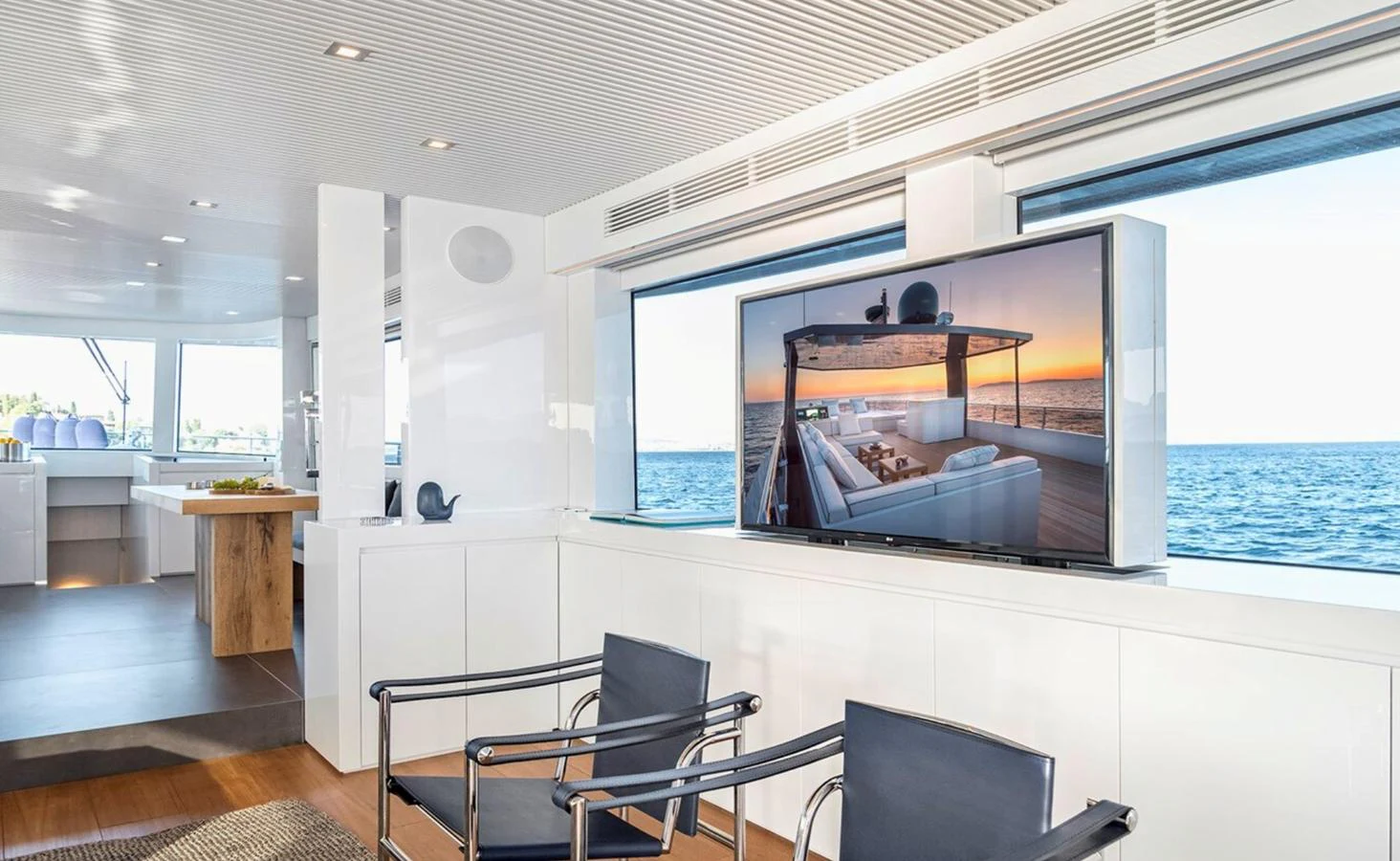 a room with a large window and a table and chairs aboard ATLASS Yacht for Sale