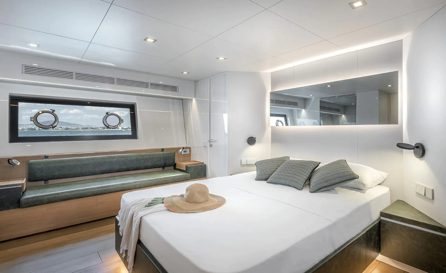 a room with a bed and a couch aboard ATLASS Yacht for Sale