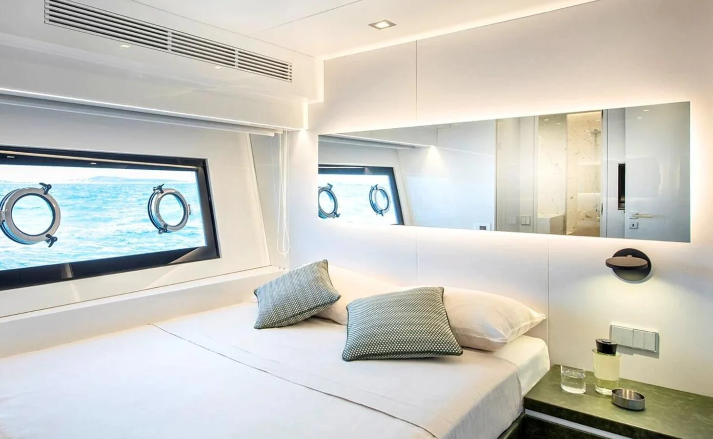 a room with a bed and a table aboard ATLASS Yacht for Sale
