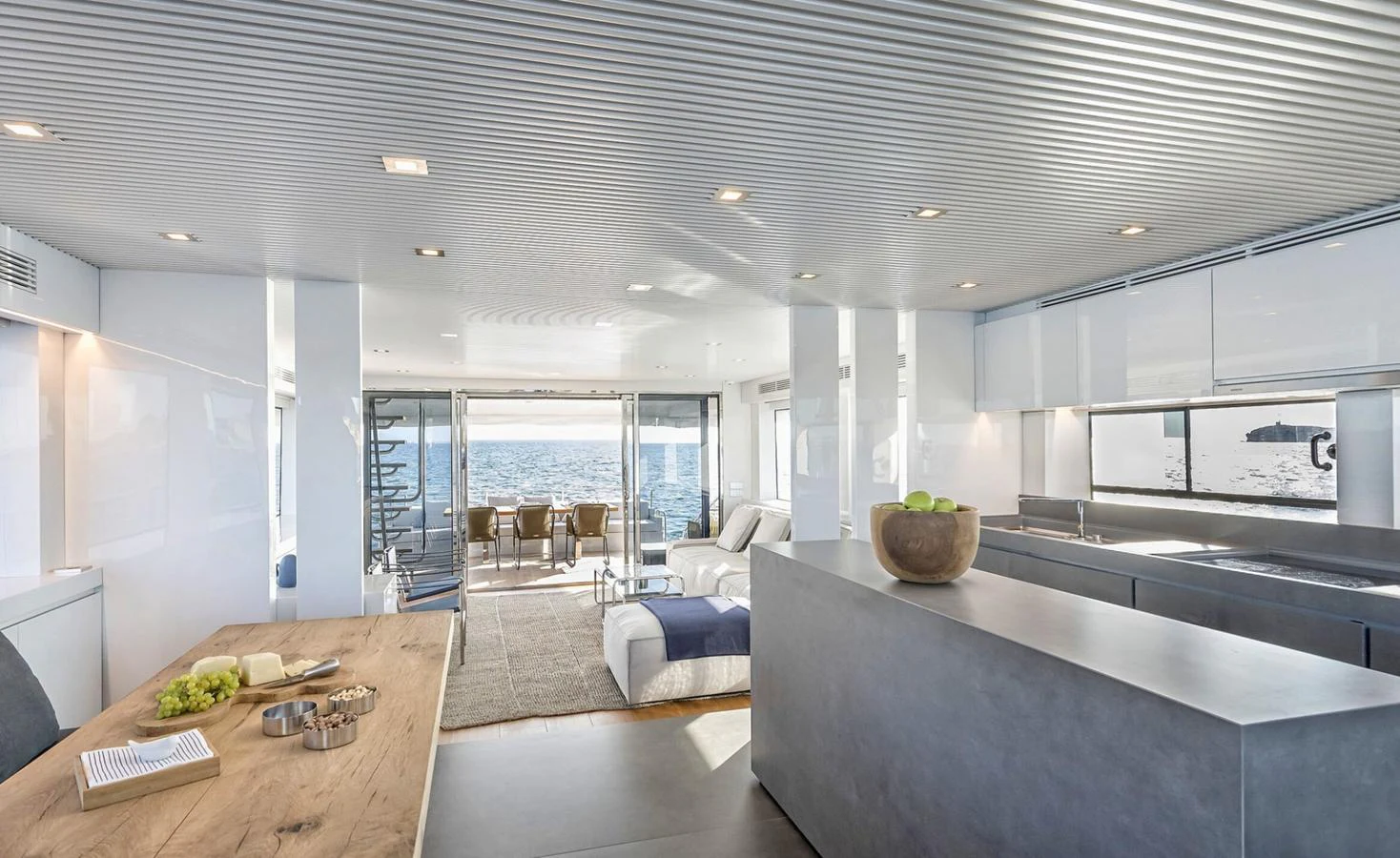 a modern looking kitchen and dining area aboard ATLASS Yacht for Sale