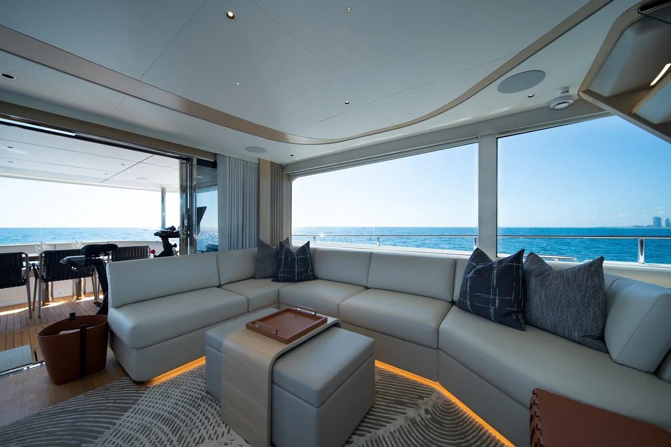 a large living room with a large window overlooking the ocean aboard MARAVI Yacht for Sale