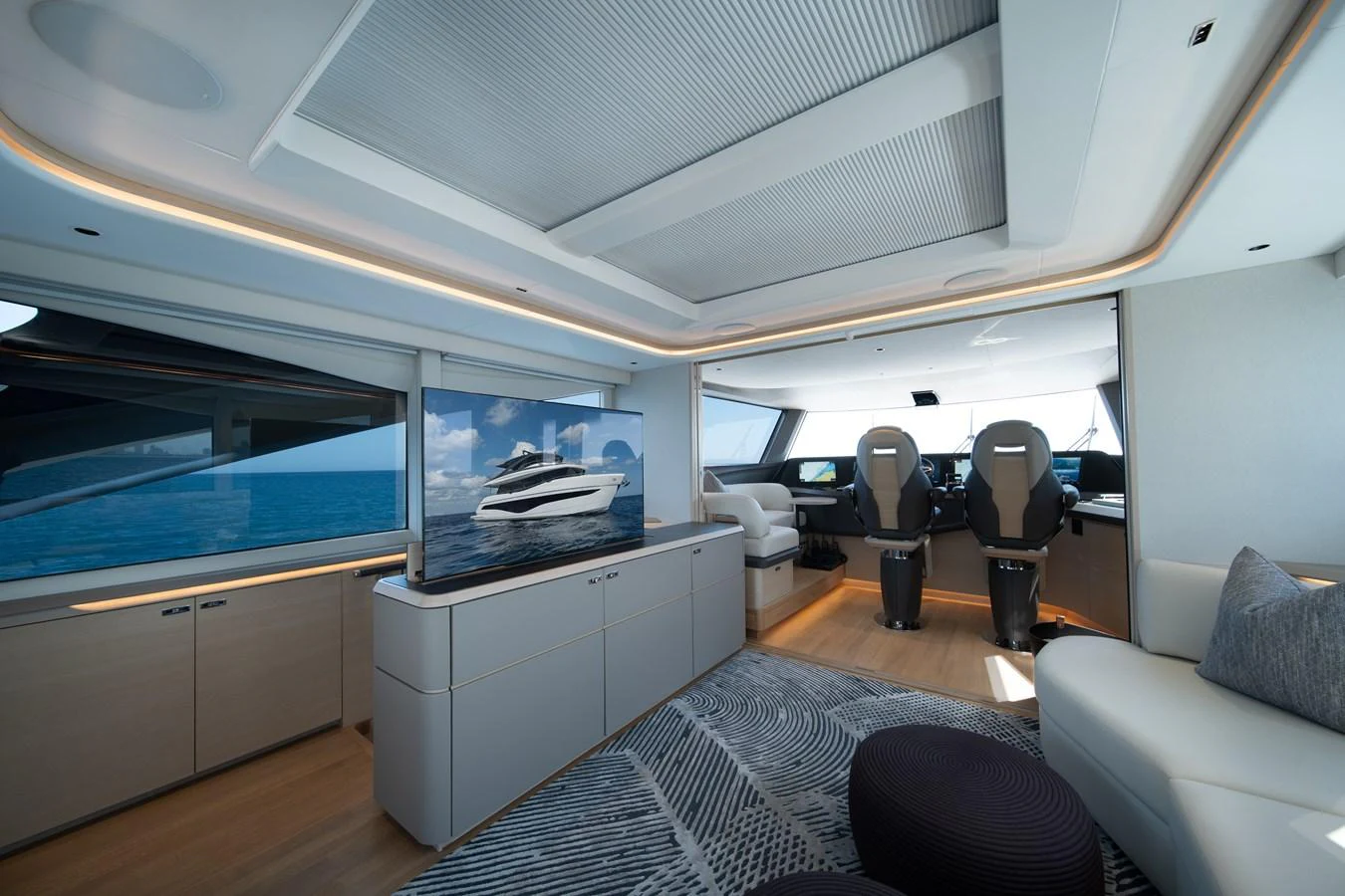 inside of a vehicle with a large window and a desk with a chair and a television on it aboard MARAVI Yacht for Sale