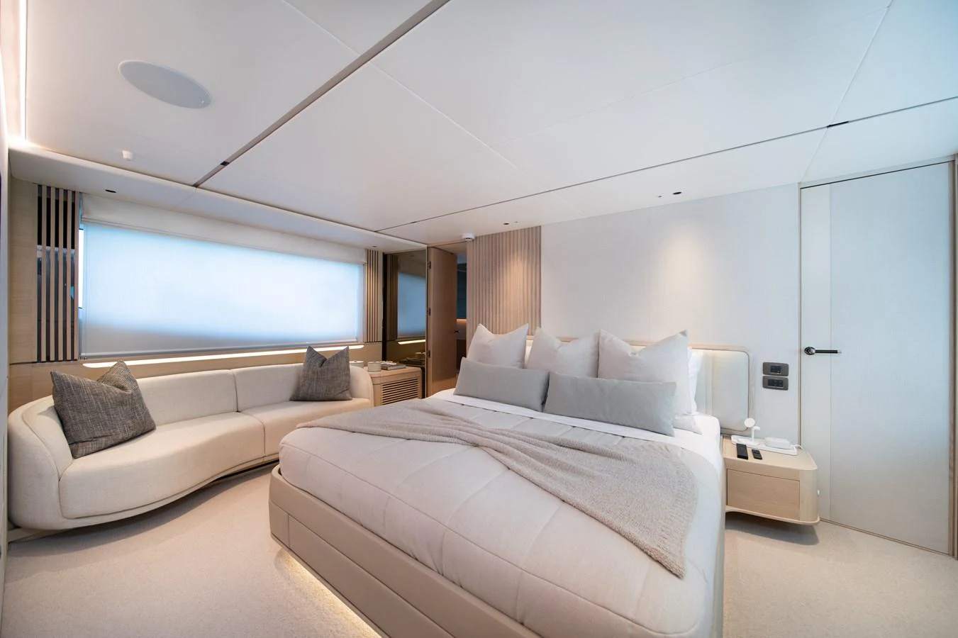 a bedroom with a bed and a couch aboard MARAVI Yacht for Sale