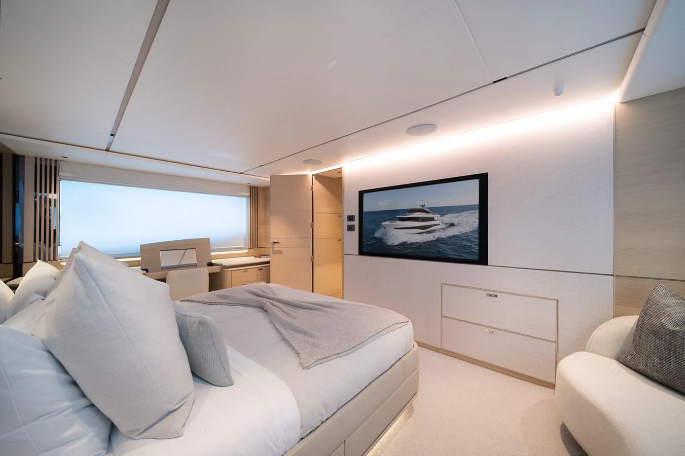 a bedroom with a bed and a television on the wall aboard MARAVI Yacht for Sale