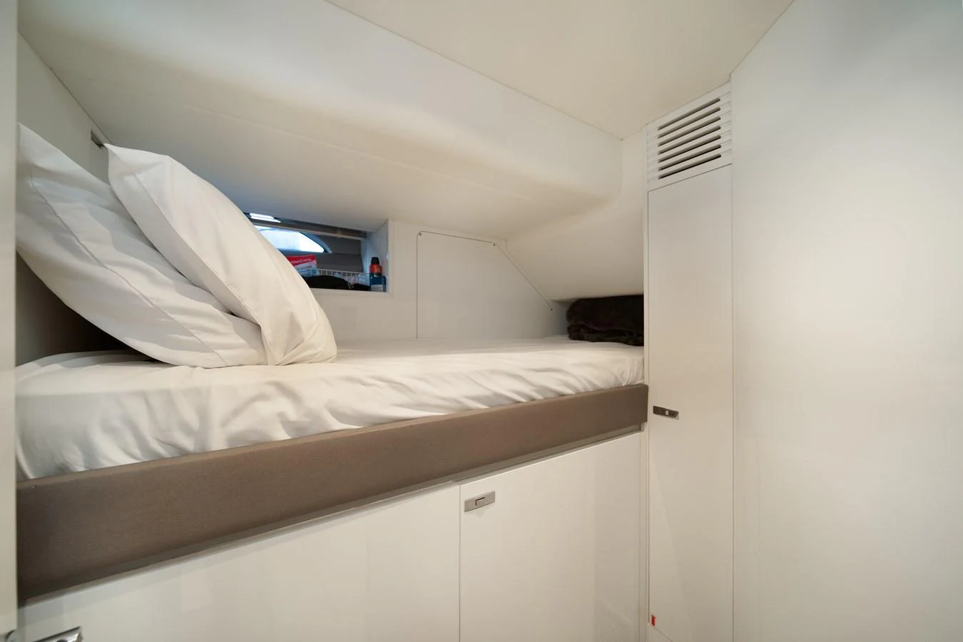 a bedroom with white walls aboard MARAVI Yacht for Sale