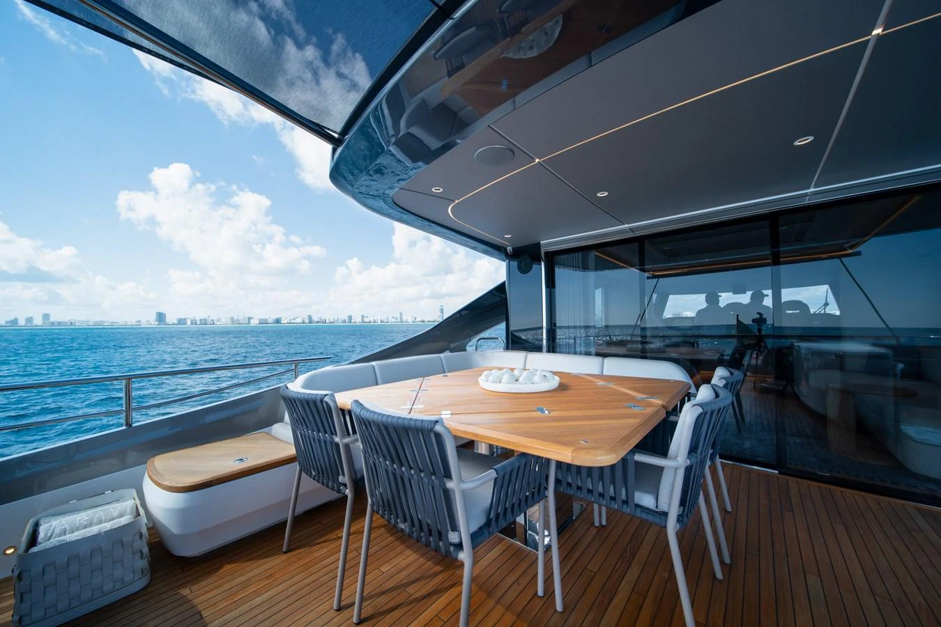 a table and chairs on a deck overlooking the ocean aboard MARAVI Yacht for Sale