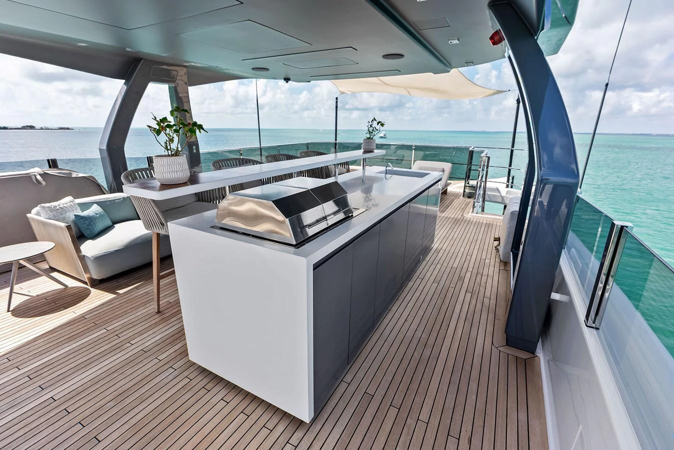 a deck with a large bed and a pool aboard LUMPASAURUS Yacht for Sale