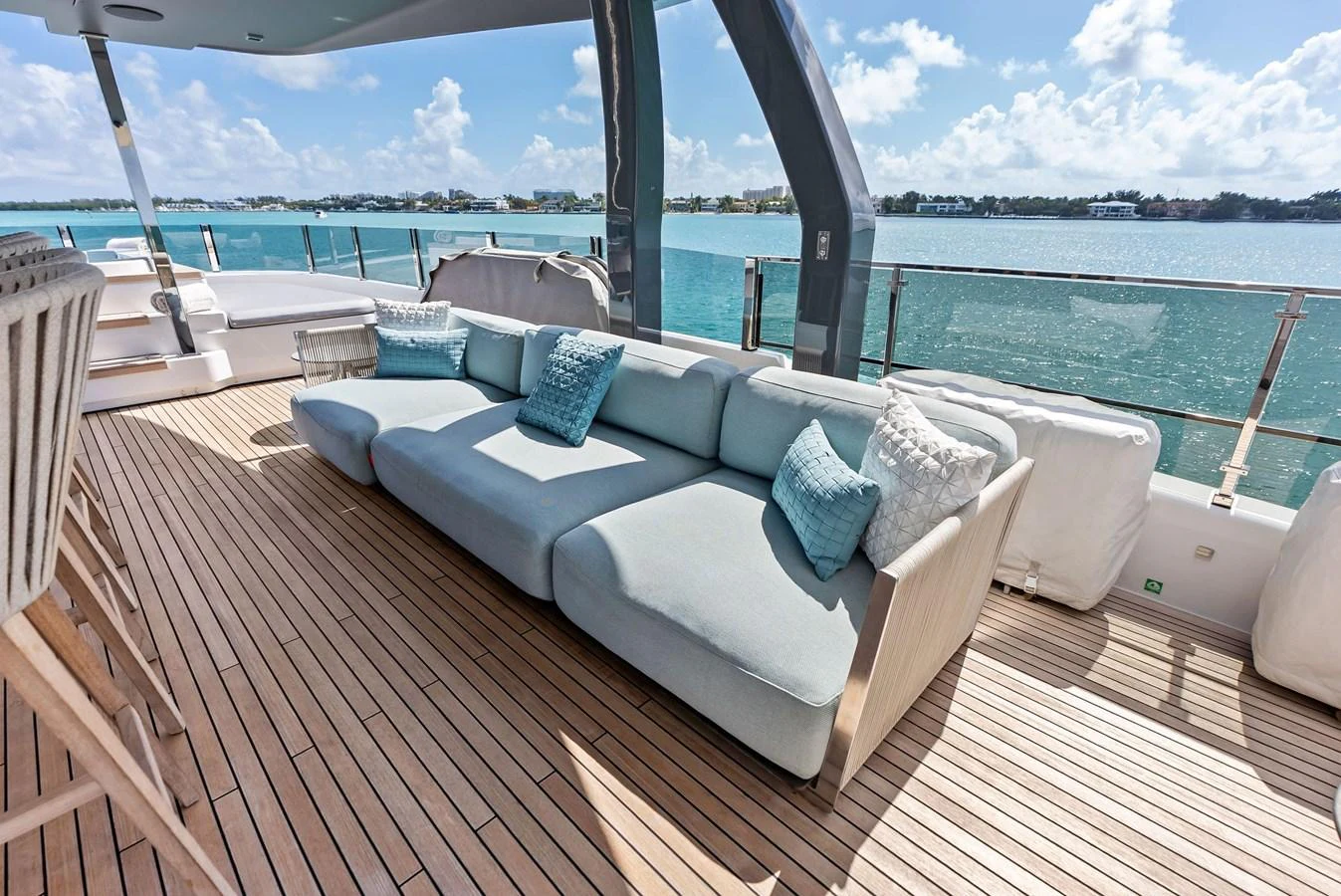 a lounge chair on a deck overlooking a body of water aboard LUMPASAURUS Yacht for Sale