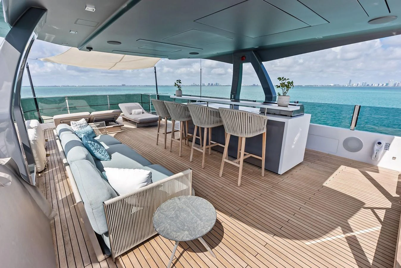 a deck with chairs and tables aboard LUMPASAURUS Yacht for Sale