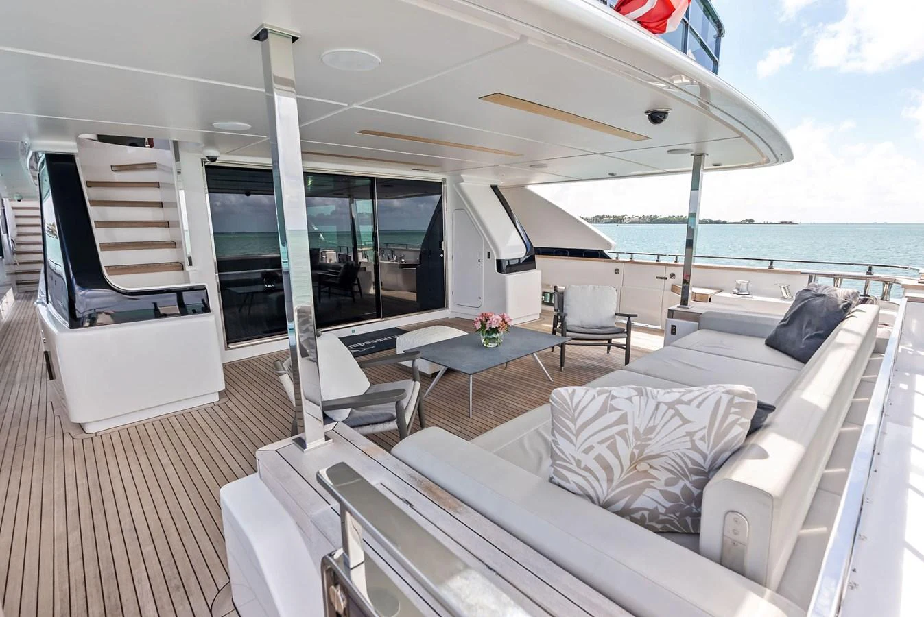 a living room with a large balcony aboard LUMPASAURUS Yacht for Sale