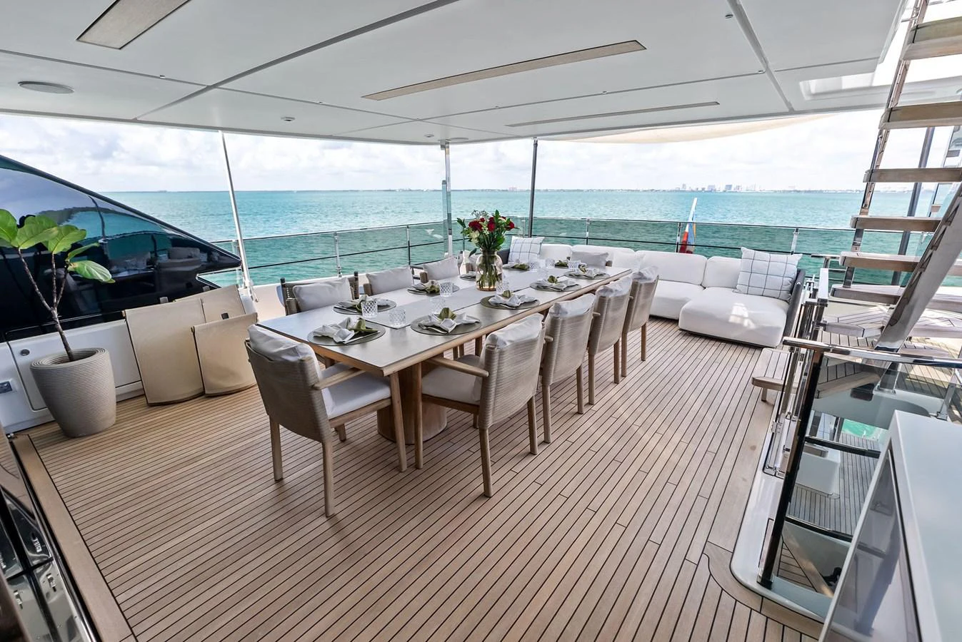 a dining room with a table and chairs aboard LUMPASAURUS Yacht for Sale