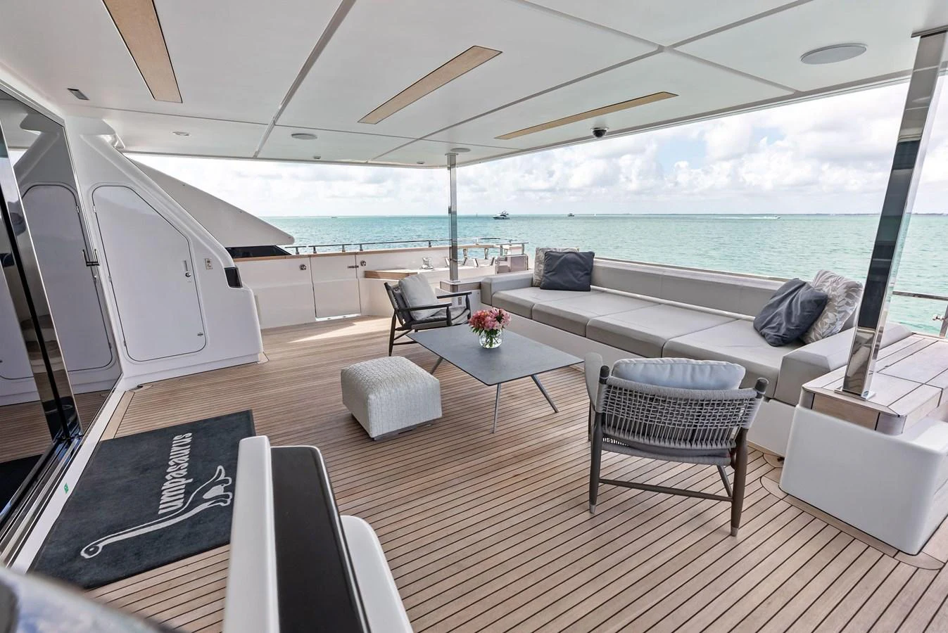 a living room with a large balcony aboard LUMPASAURUS Yacht for Sale