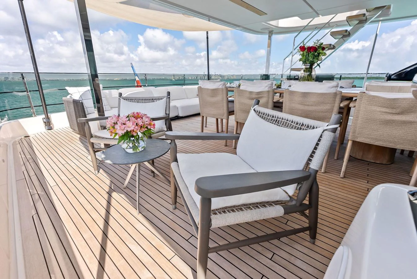 a deck with chairs and tables on it aboard LUMPASAURUS Yacht for Sale