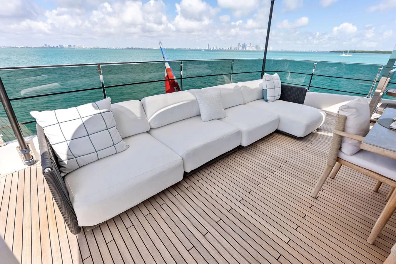 a white couch on a deck overlooking the ocean aboard LUMPASAURUS Yacht for Sale
