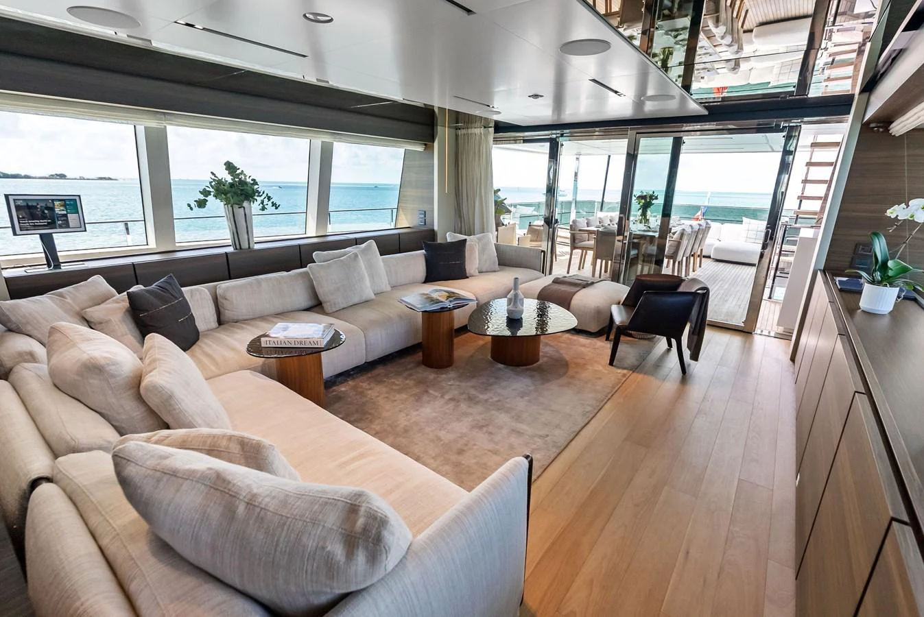 a living room with a large window aboard LUMPASAURUS Yacht for Sale
