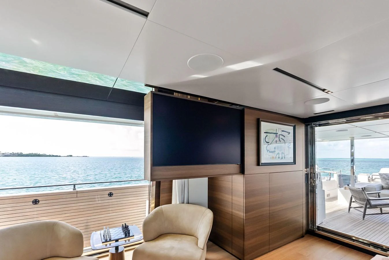 a room with a tv and furniture aboard LUMPASAURUS Yacht for Sale