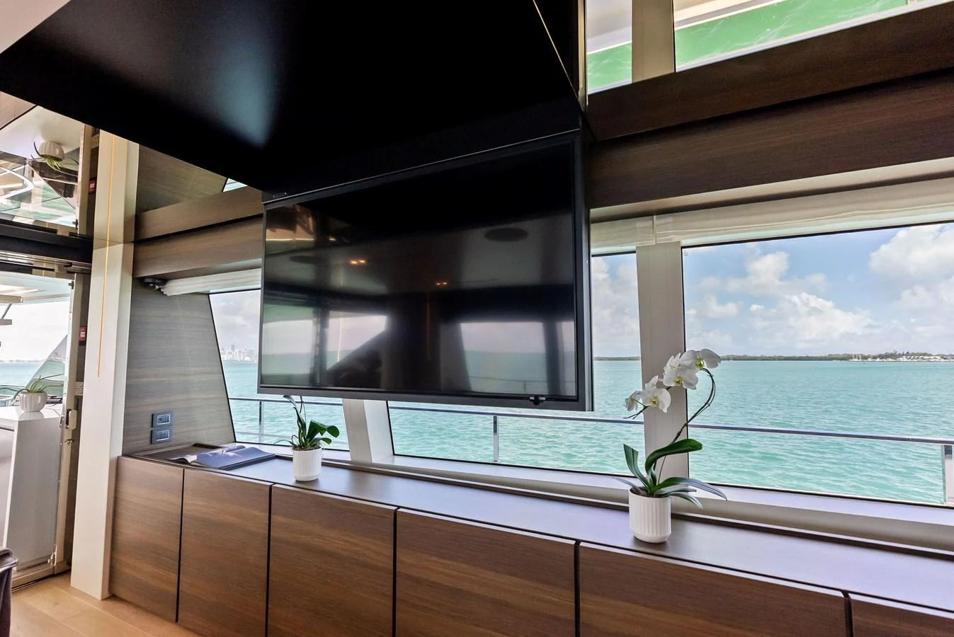 a room with a window and a plant in it aboard LUMPASAURUS Yacht for Sale