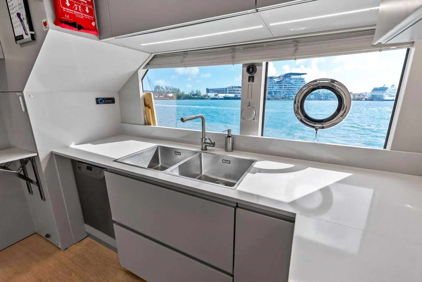 a kitchen with a sink and a window aboard LUMPASAURUS Yacht for Sale