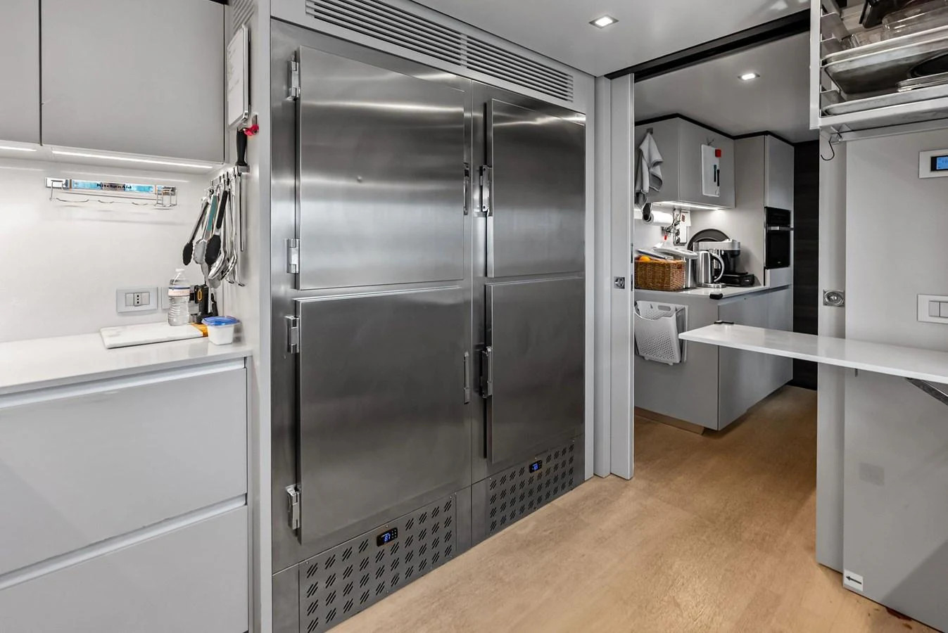 a large kitchen with stainless steel appliances aboard LUMPASAURUS Yacht for Sale
