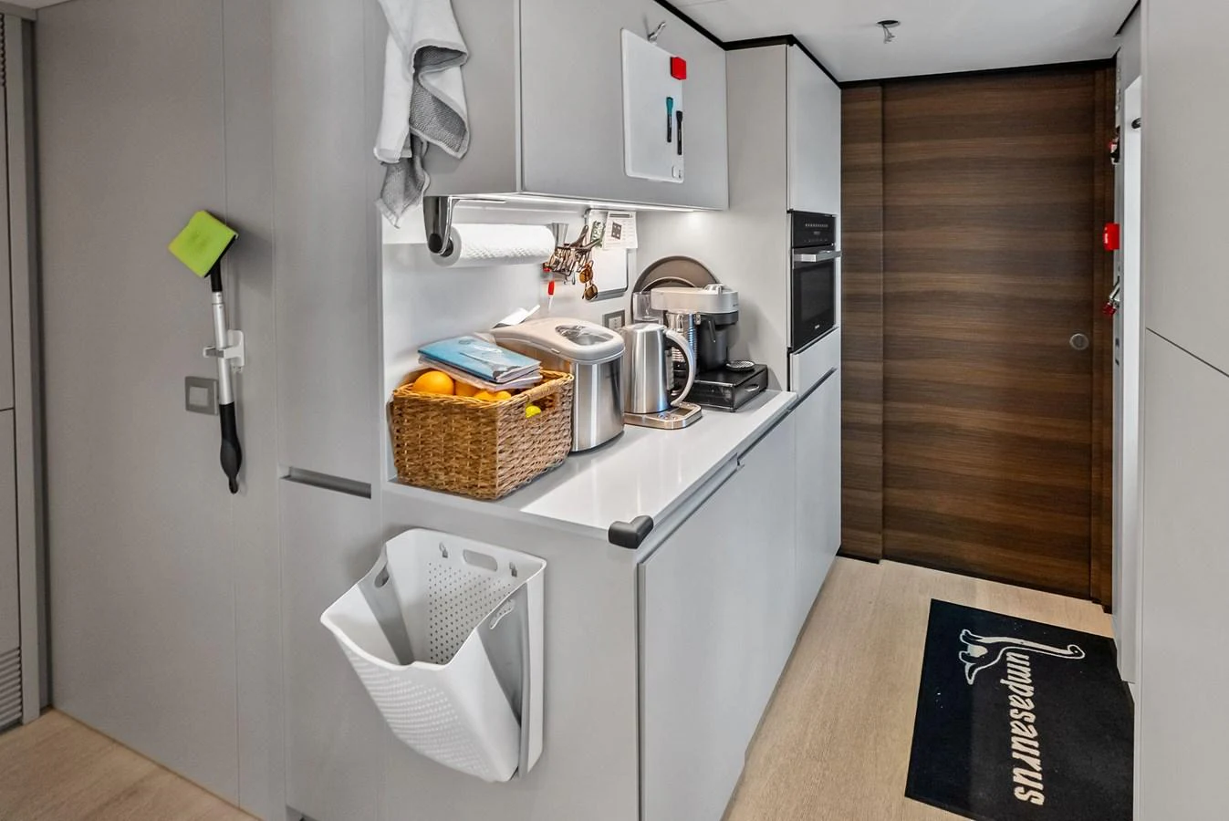 a kitchen with a sink and a basket aboard LUMPASAURUS Yacht for Sale