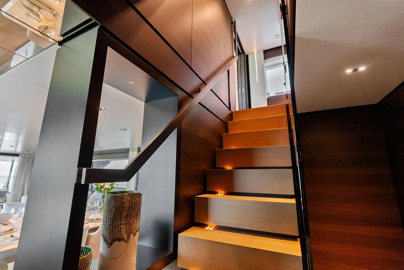 a wooden staircase with a planter aboard LUMPASAURUS Yacht for Sale