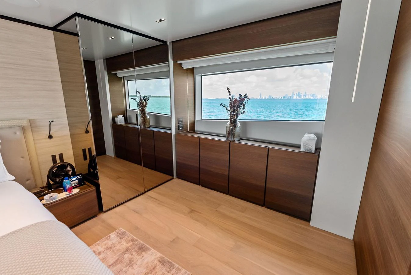 a room with a large window and a wood floor aboard LUMPASAURUS Yacht for Sale