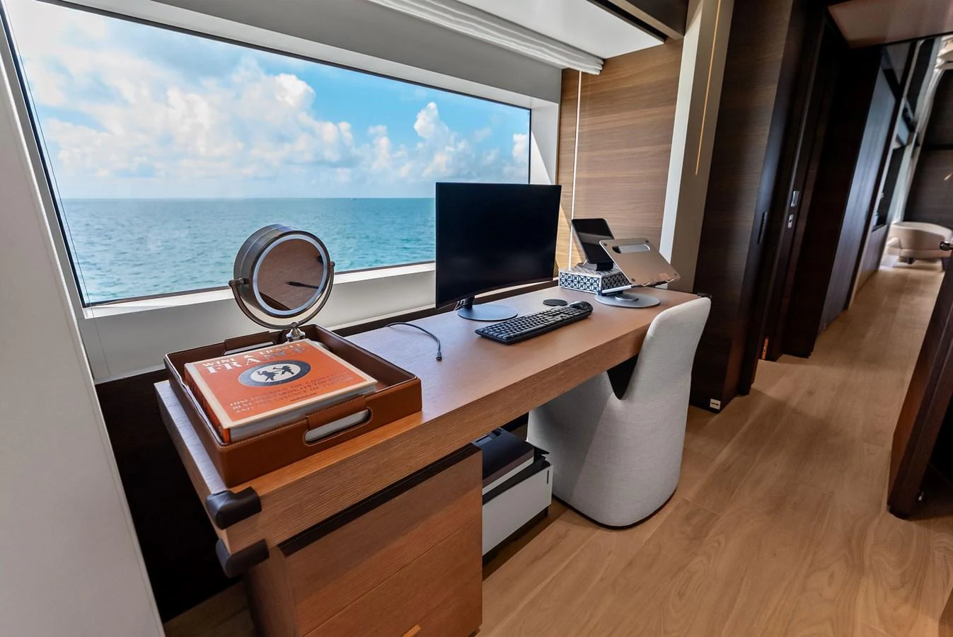a room with a desk and a window aboard LUMPASAURUS Yacht for Sale