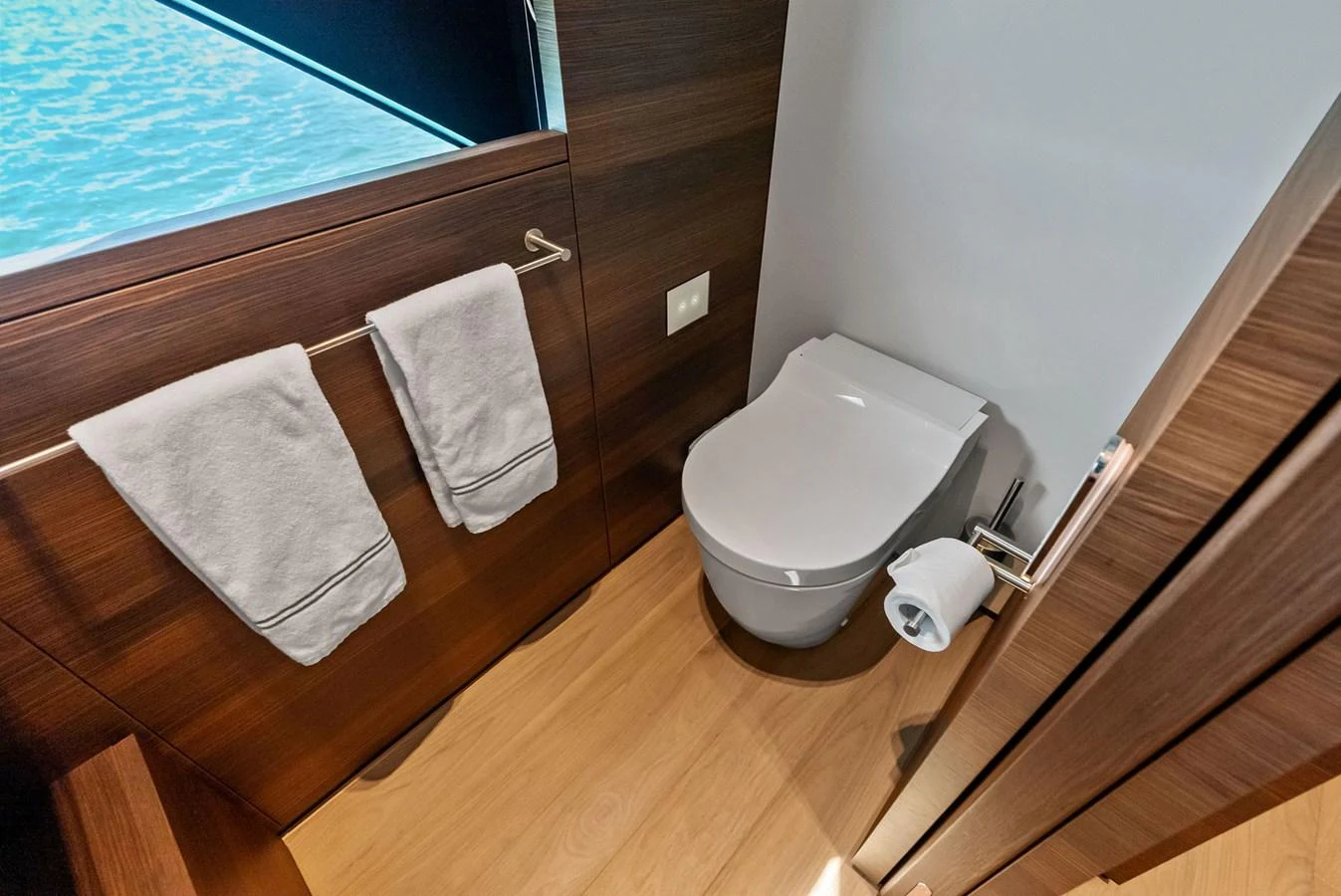 a bathroom with a wooden floor aboard LUMPASAURUS Yacht for Sale