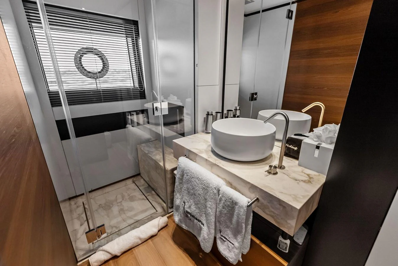 a bathroom with a sink and a mirror aboard LUMPASAURUS Yacht for Sale