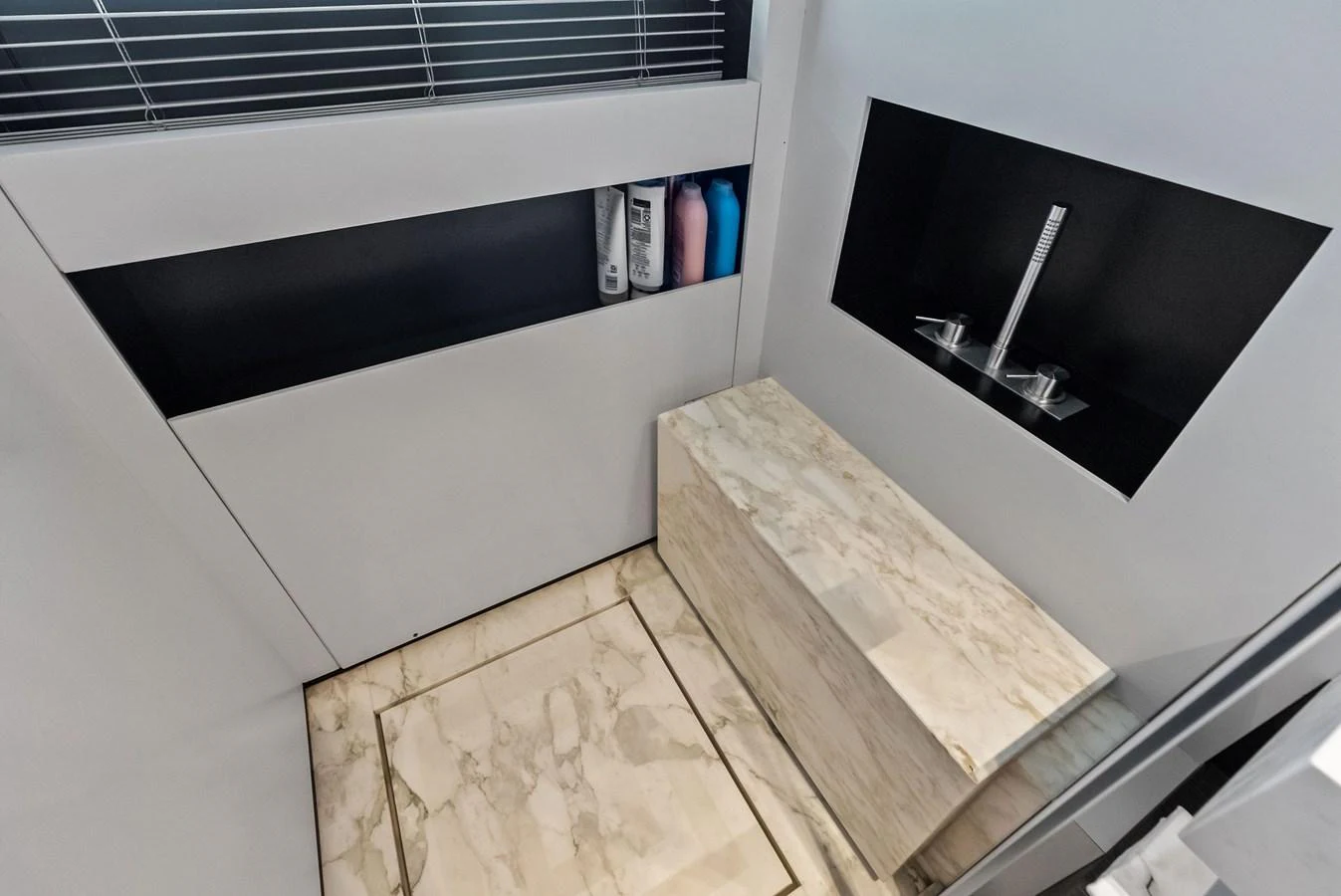 a room with a tv and a shelf with objects on it aboard LUMPASAURUS Yacht for Sale