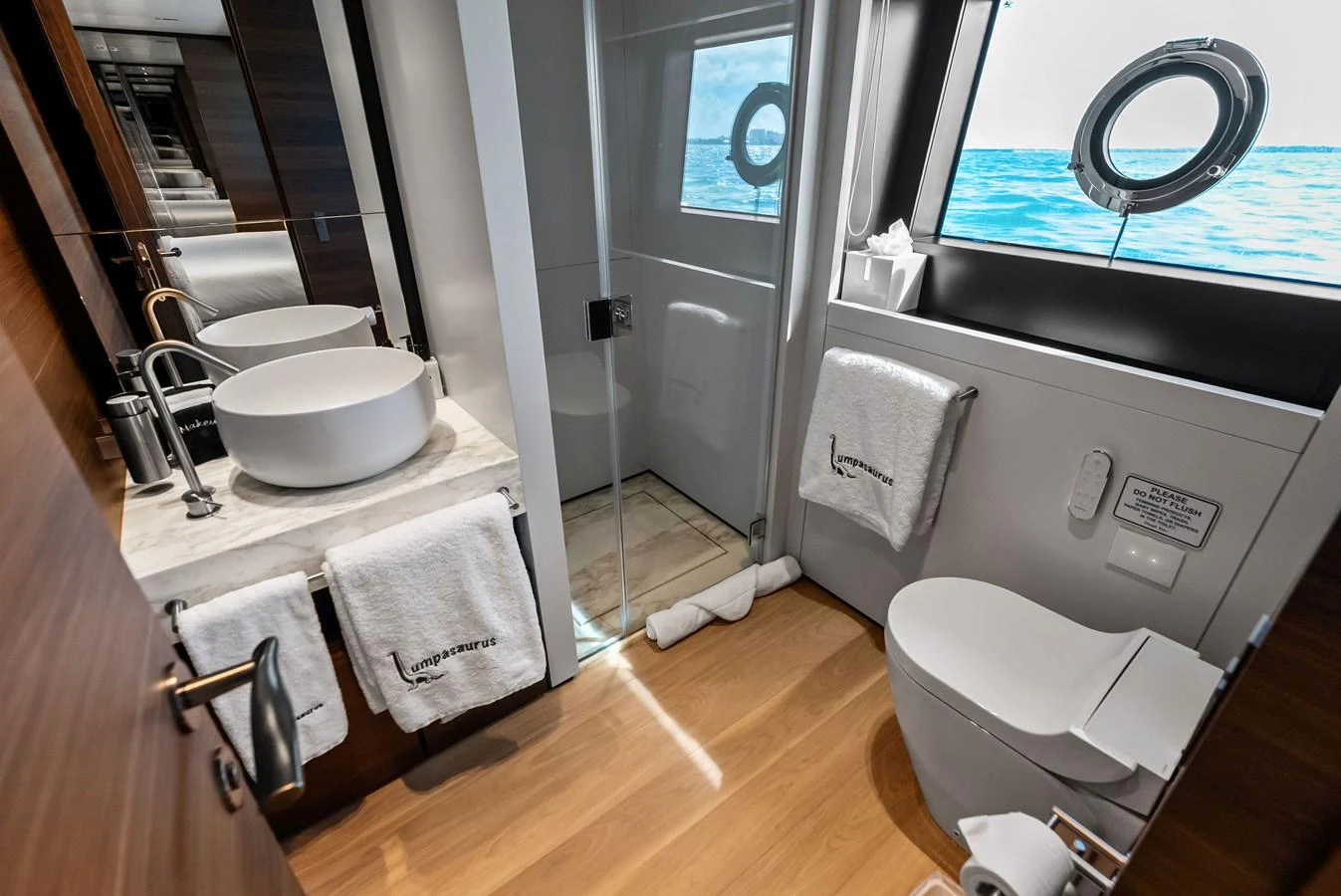 a bathroom with a sink toilet and a bathtub aboard LUMPASAURUS Yacht for Sale