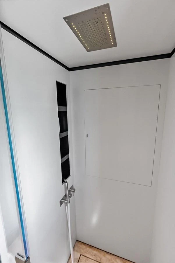 a door with a light on the wall aboard LUMPASAURUS Yacht for Sale