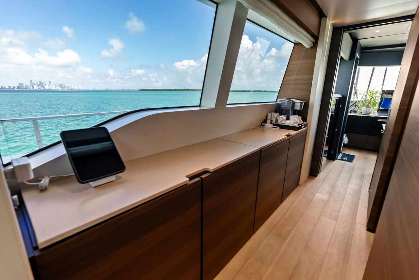 a room with a large window overlooking the ocean aboard LUMPASAURUS Yacht for Sale