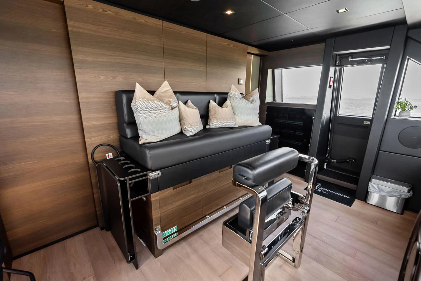 a living room with a couch and a table aboard LUMPASAURUS Yacht for Sale