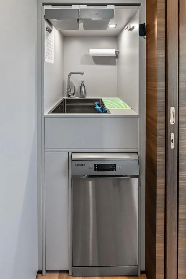 a stainless steel refrigerator in a kitchen aboard LUMPASAURUS Yacht for Sale