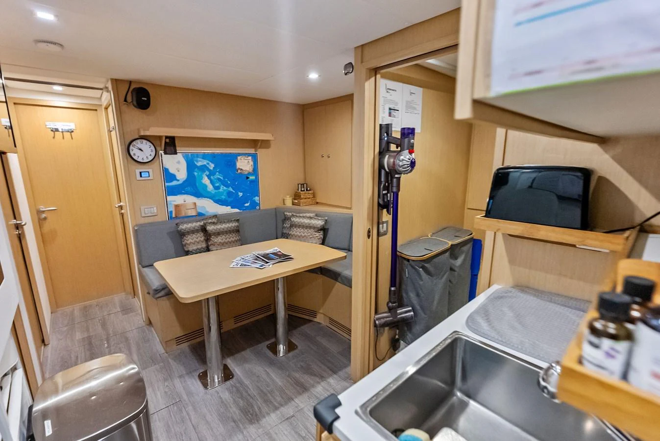 a kitchen with a sink and a table aboard LUMPASAURUS Yacht for Sale