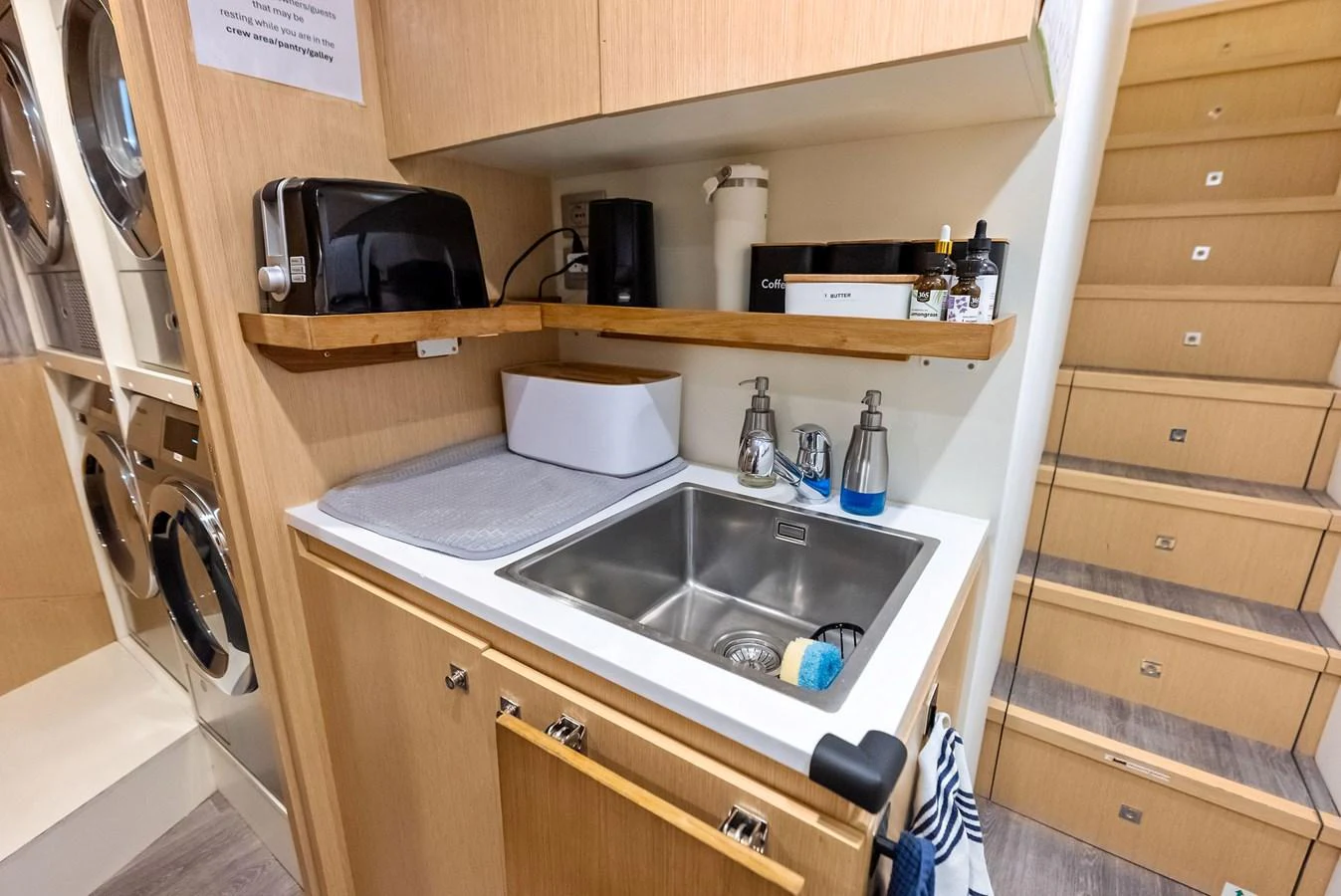 a kitchen with a sink and a toaster oven aboard LUMPASAURUS Yacht for Sale