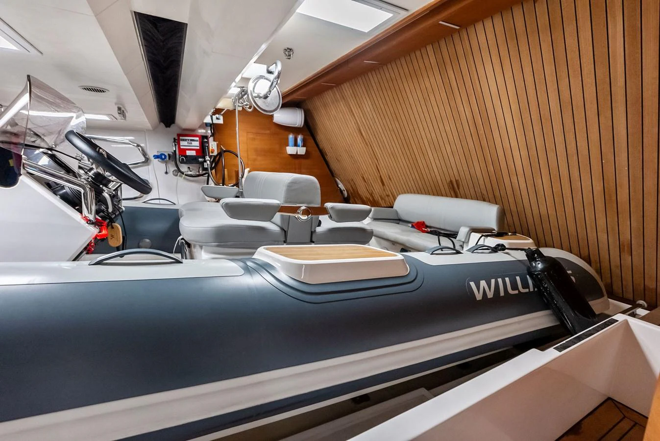 a room with a bed and desks aboard LUMPASAURUS Yacht for Sale