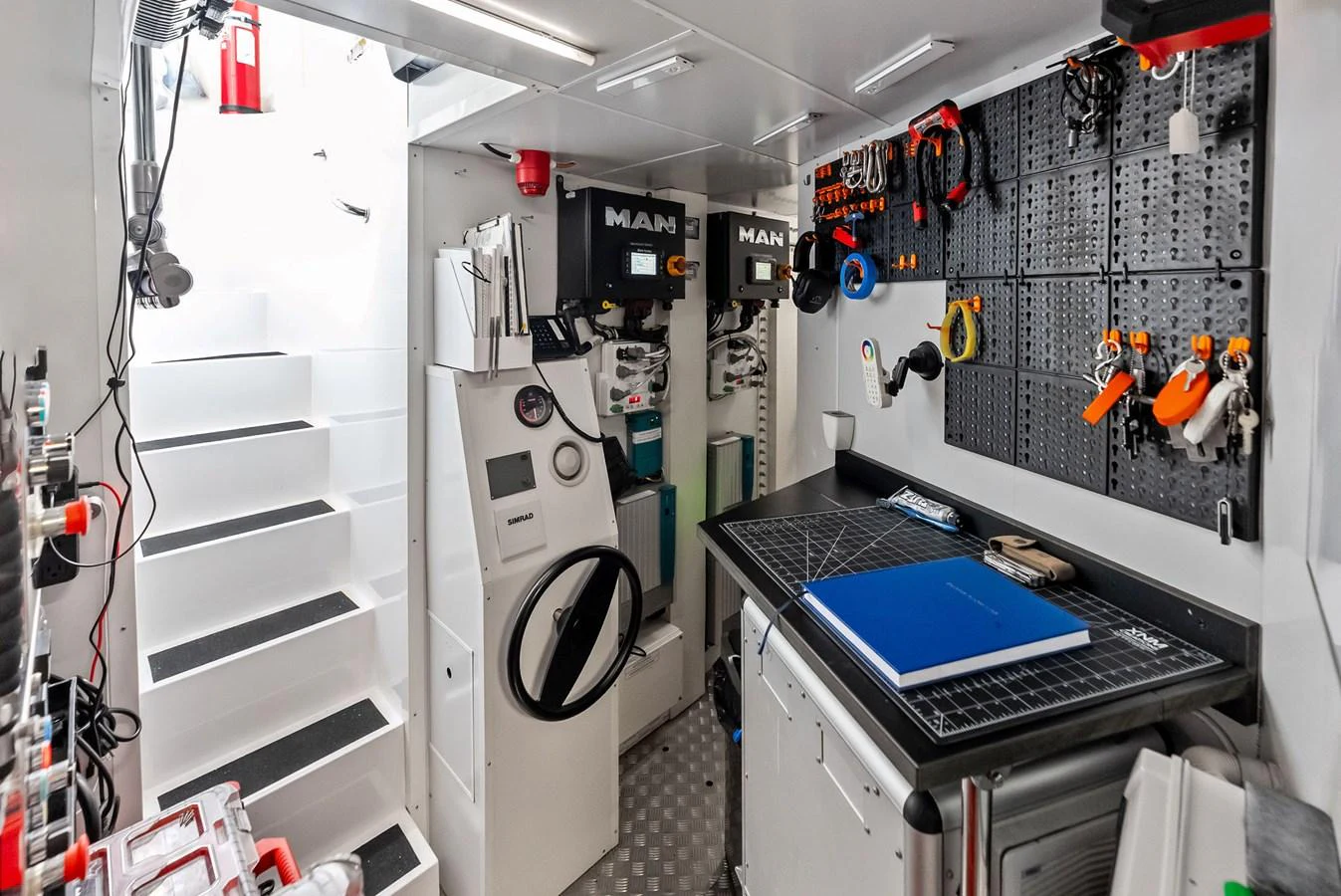 a room with a computer and a large fan aboard LUMPASAURUS Yacht for Sale