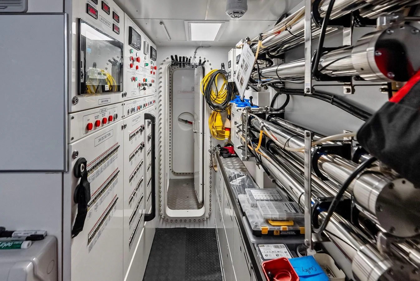 a room with white walls and machinery aboard LUMPASAURUS Yacht for Sale