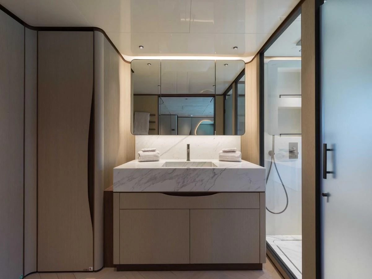 The yacht's bathroom features modern fixtures and a sleek design with ample lighting. aboard PESA II Yacht for Sale